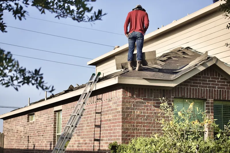 Professional roofer working on a residential roof in North Bridgewater